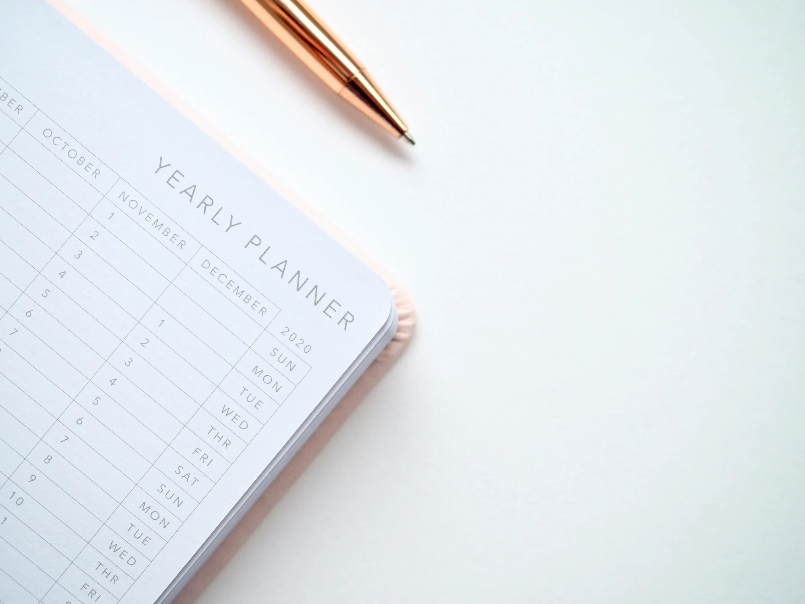 Yearly planner and pen for attendance and leave tracking