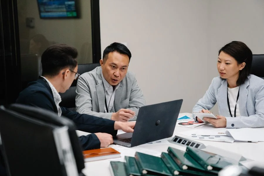 Leadership meeting on post-merger HR and payroll compliance